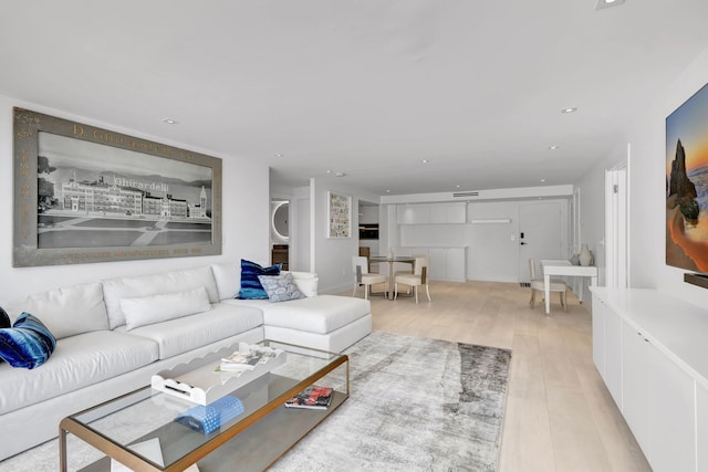 3456 S Ocean Blvd Unit 2060, Palm Beach, FL 33480 - living area featuring estacked washer and dryer and light wood finished floors