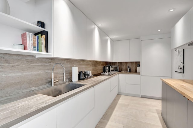 3456 S Ocean Blvd Unit 2060, Palm Beach, FL 33480 - kitchen featuring a sink, backsplash, white cabinets, modern cabinets, and recessed lighting