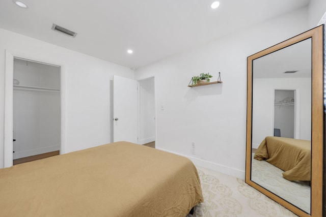 bedroom featuring a walk in closet and a closet