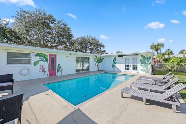 view of swimming pool featuring french doors and a patio area