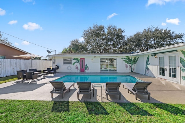 view of pool with french doors and a patio