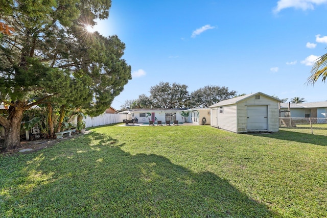 view of yard featuring a patio and a storage shed