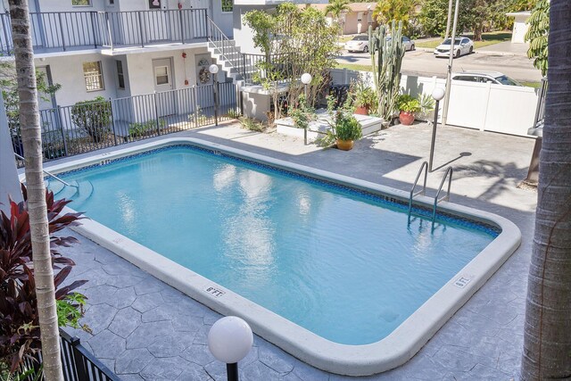 714 NE 10th St Unit 205, Hallandale Beach, FL 33009 - community pool with fence, stairway, and a patio area