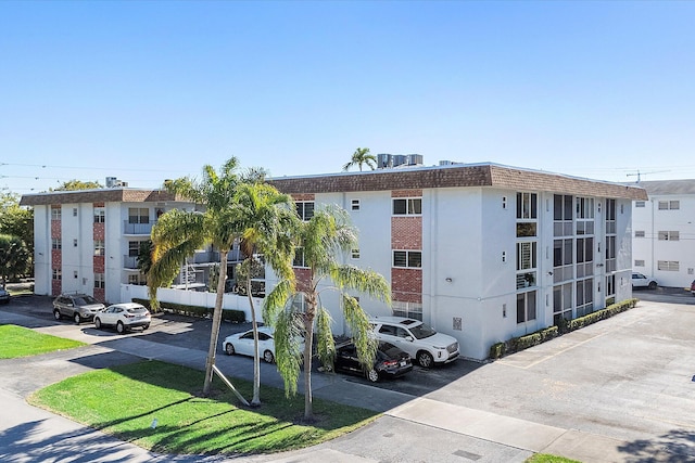 714 NE 10th St Unit 205, Hallandale Beach, FL 33009 - view of building exterior with uncovered parking