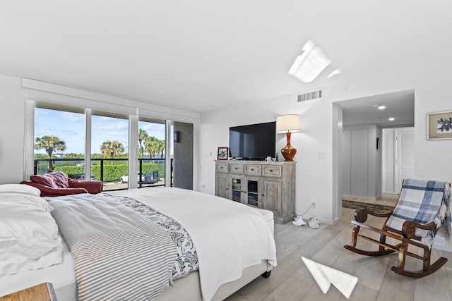 bedroom featuring light wood-type flooring and access to exterior