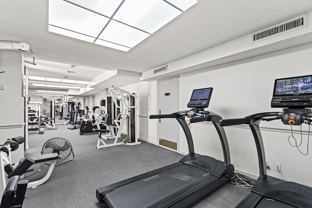 workout area featuring a textured ceiling