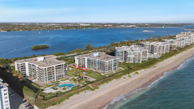 birds eye view of property featuring a view of the beach and a water view