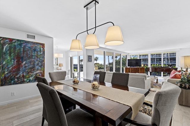 dining space featuring light wood-type flooring