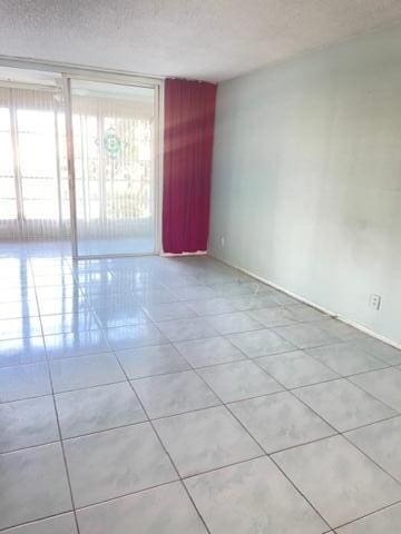 spare room with light tile patterned floors