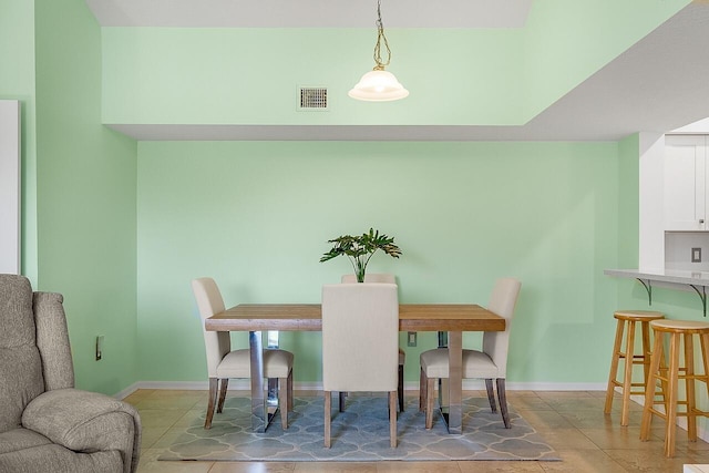 dining space with tile patterned flooring