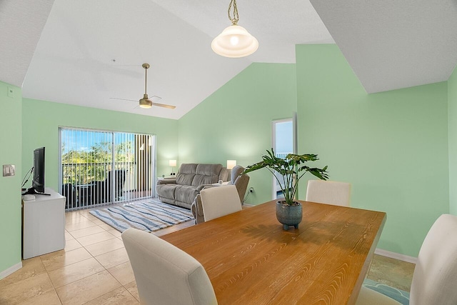 dining room featuring ceiling fan, light tile patterned flooring, and high vaulted ceiling