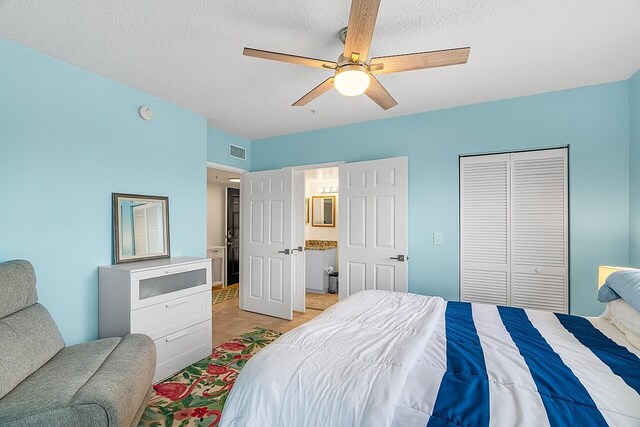 tiled bedroom with a closet, a textured ceiling, access to outside, and ceiling fan