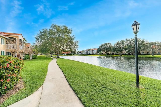 view of community featuring a yard and a water view