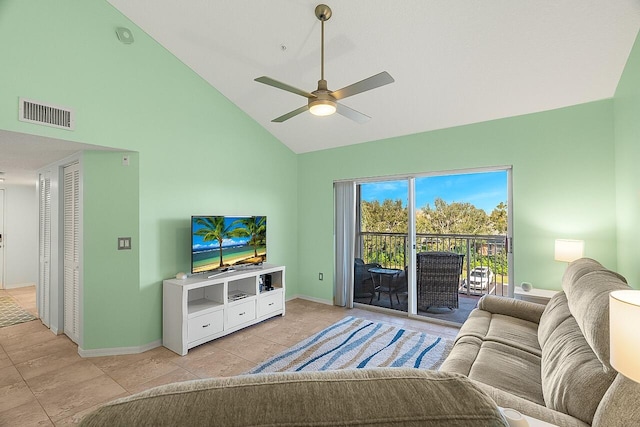 tiled living room with ceiling fan and high vaulted ceiling