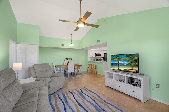 living room with ceiling fan and high vaulted ceiling