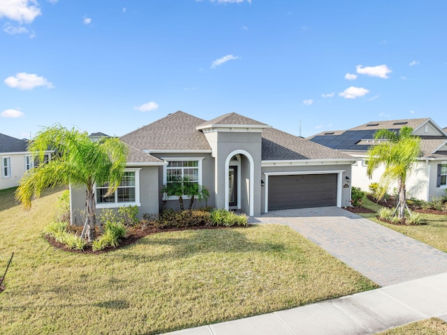 view of front of home with a front yard and a garage