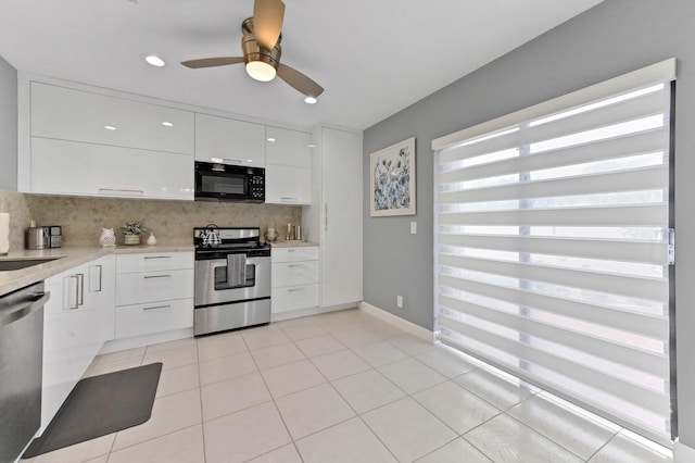 5650 Parkwalk Cir E, Boynton Beach, FL 33472 - kitchen featuring light countertops, white cabinetry, tasteful backsplash, appliances with stainless steel finishes, and light tile patterned floors