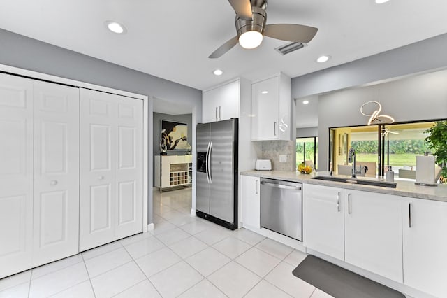 5650 Parkwalk Cir E, Boynton Beach, FL 33472 - kitchen with light tile patterned floors, a sink, visible vents, white cabinets, and appliances with stainless steel finishes