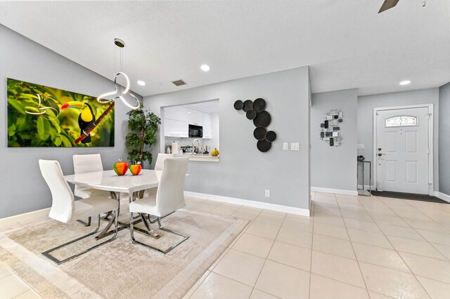 kitchen featuring appliances with stainless steel finishes, white cabinetry, tasteful backsplash, sink, and ceiling fan