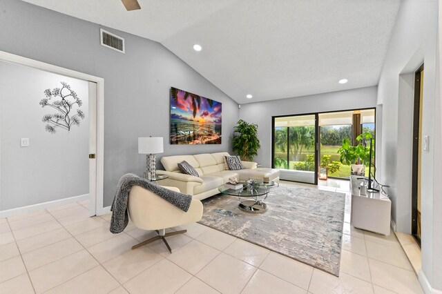 tiled living room featuring vaulted ceiling