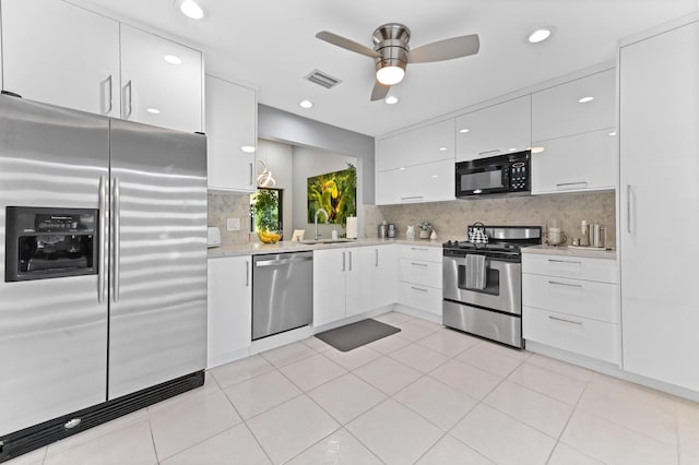 5650 Parkwalk Cir E, Boynton Beach, FL 33472 - kitchen with light countertops, visible vents, appliances with stainless steel finishes, white cabinetry, and a sink