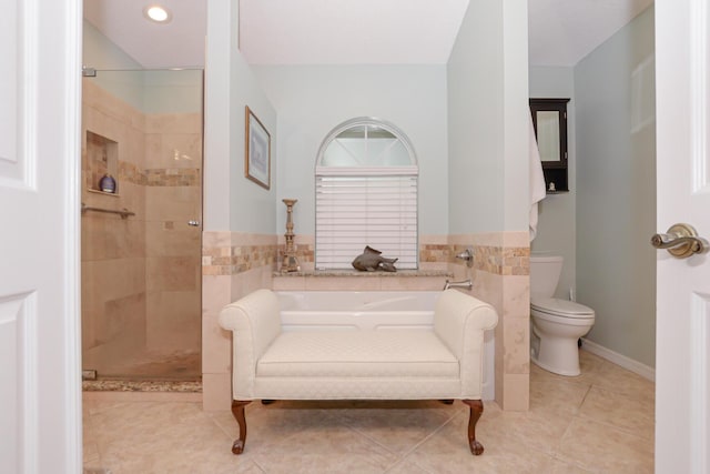 bathroom featuring toilet, shower with separate bathtub, and tile patterned floors