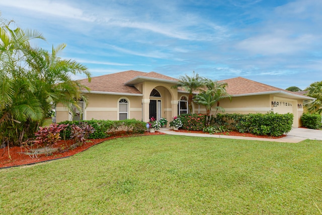 view of front facade with a garage and a front lawn