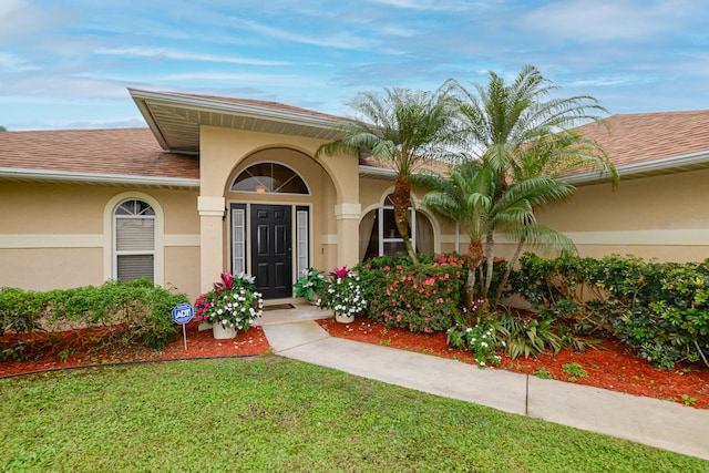 entrance to property featuring a yard