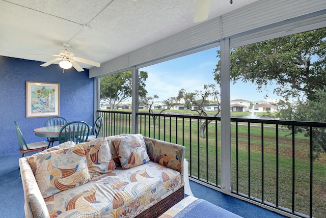 sunroom featuring ceiling fan