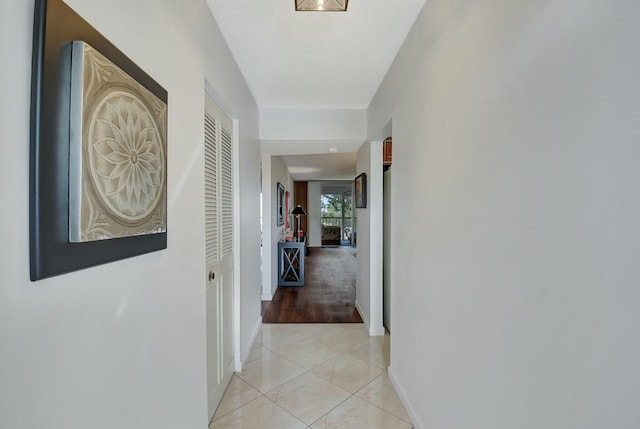 hall featuring light tile patterned flooring