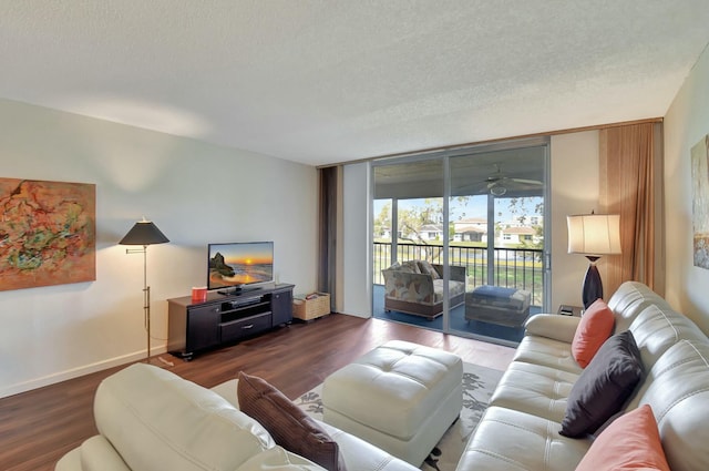 living room with dark hardwood / wood-style flooring, a textured ceiling, ceiling fan, and expansive windows