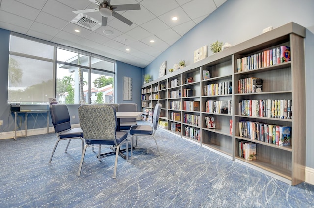 carpeted office space featuring ceiling fan