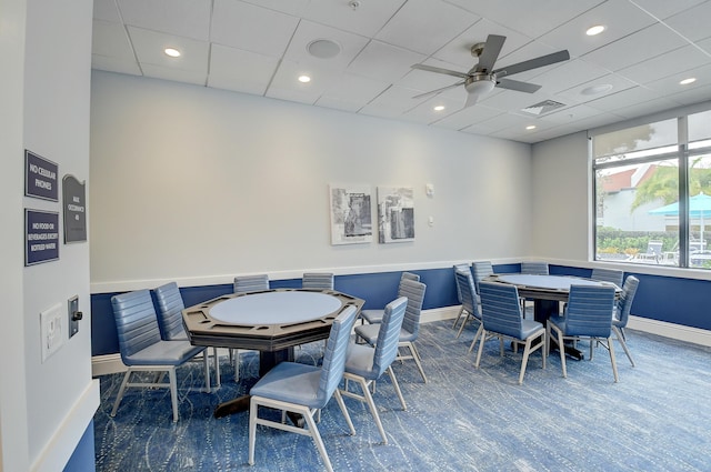 dining area featuring a drop ceiling and ceiling fan