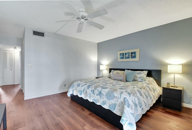 bedroom with ceiling fan and wood-type flooring