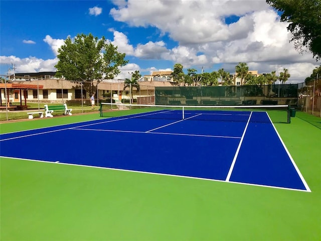 view of tennis court with basketball hoop