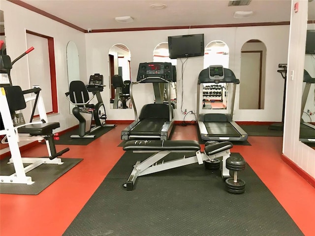 exercise room featuring crown molding