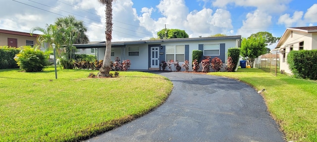 ranch-style home featuring a front yard