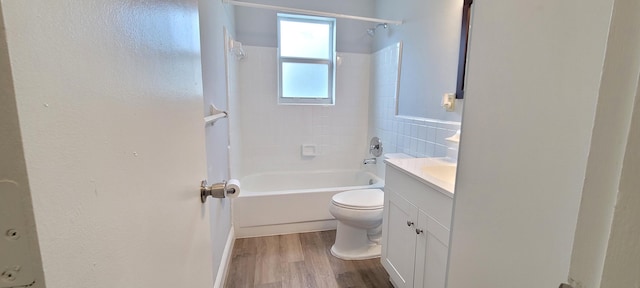 full bathroom with toilet, vanity, tiled shower / bath combo, and hardwood / wood-style flooring