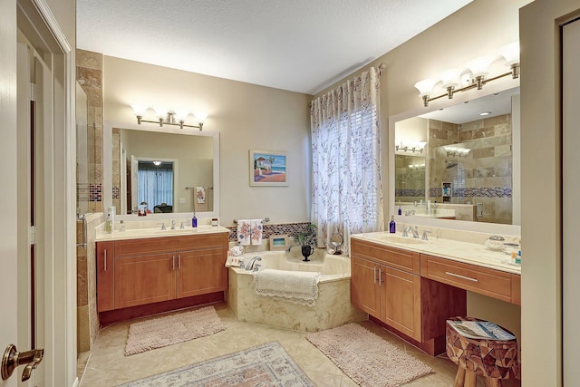 full bathroom with a sink, a garden tub, two vanities, and a stall shower