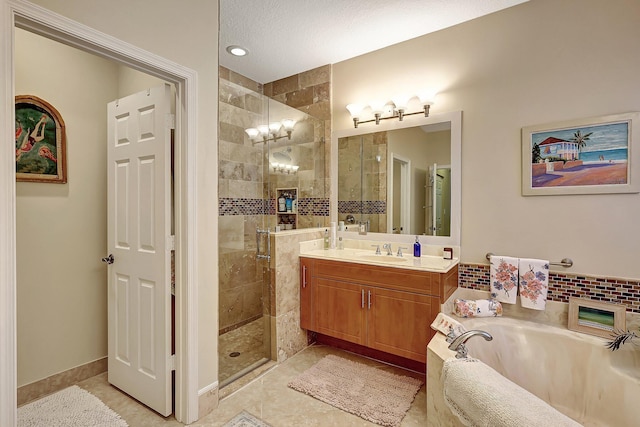 bathroom featuring a shower stall, tile patterned floors, baseboards, a bath, and vanity