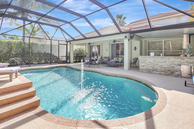 view of swimming pool with a fenced in pool, a lanai, a ceiling fan, and a patio area