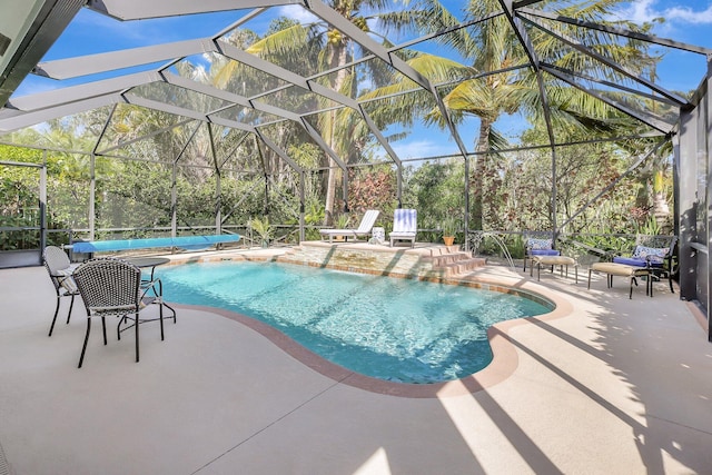 pool with a lanai and a patio area