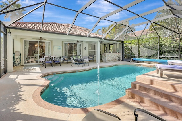 pool with a patio area, glass enclosure, a hot tub, and ceiling fan