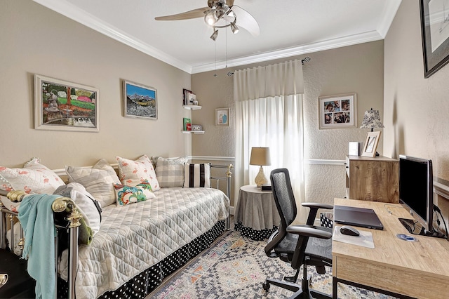 bedroom with a ceiling fan, a textured wall, and ornamental molding