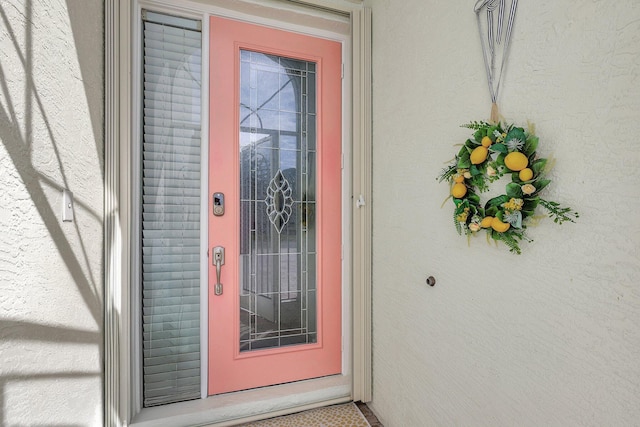 property entrance with stucco siding