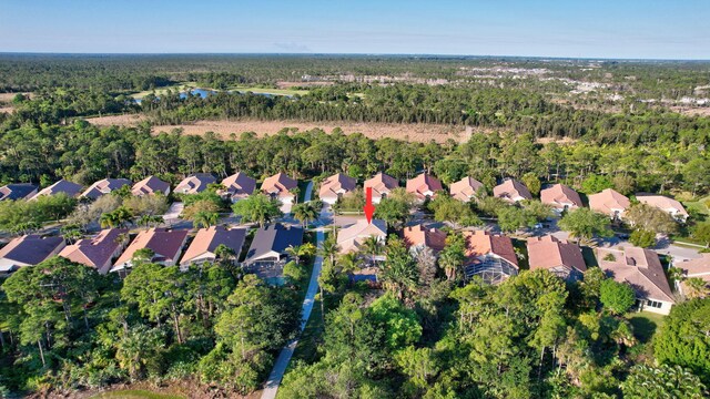 bird's eye view with a wooded view and a residential view