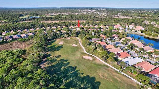 aerial view featuring a residential view, a view of trees, view of golf course, and a water view