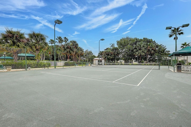 view of sport court featuring fence