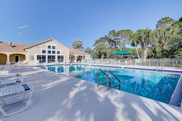 pool featuring a patio and fence