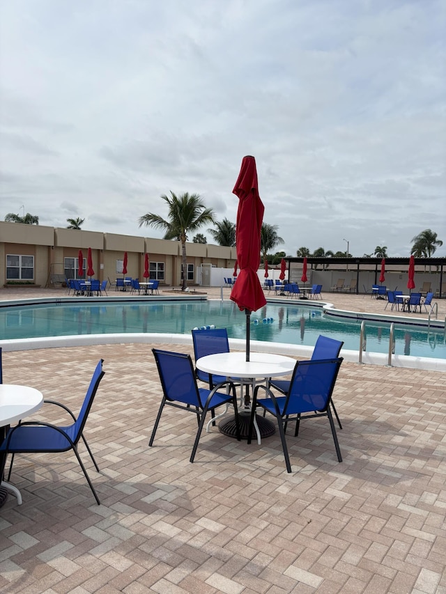 pool featuring a patio and fence